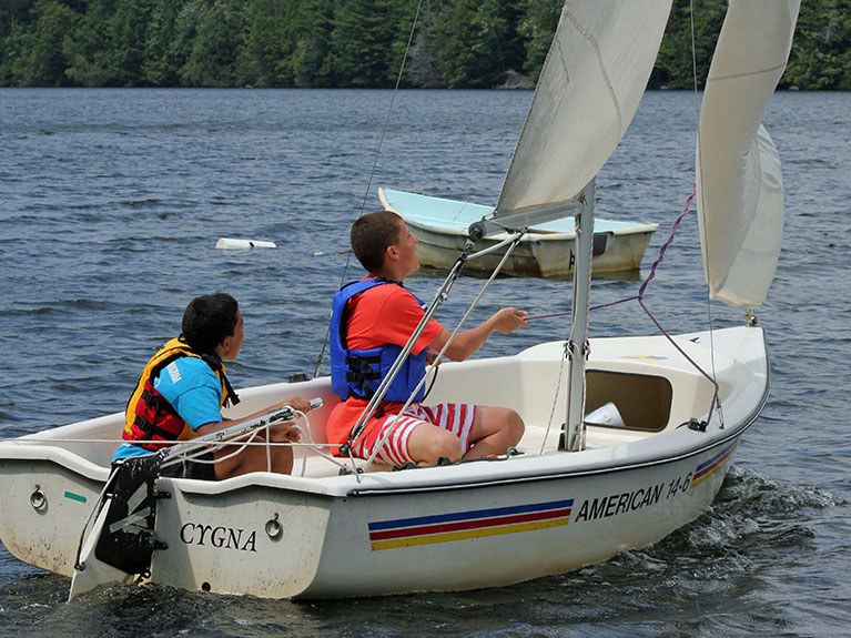 Campers sailing on lake in boat