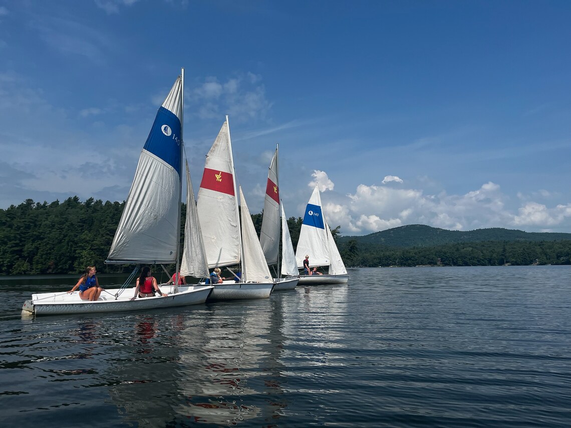 A row of sailboats ready to start a race